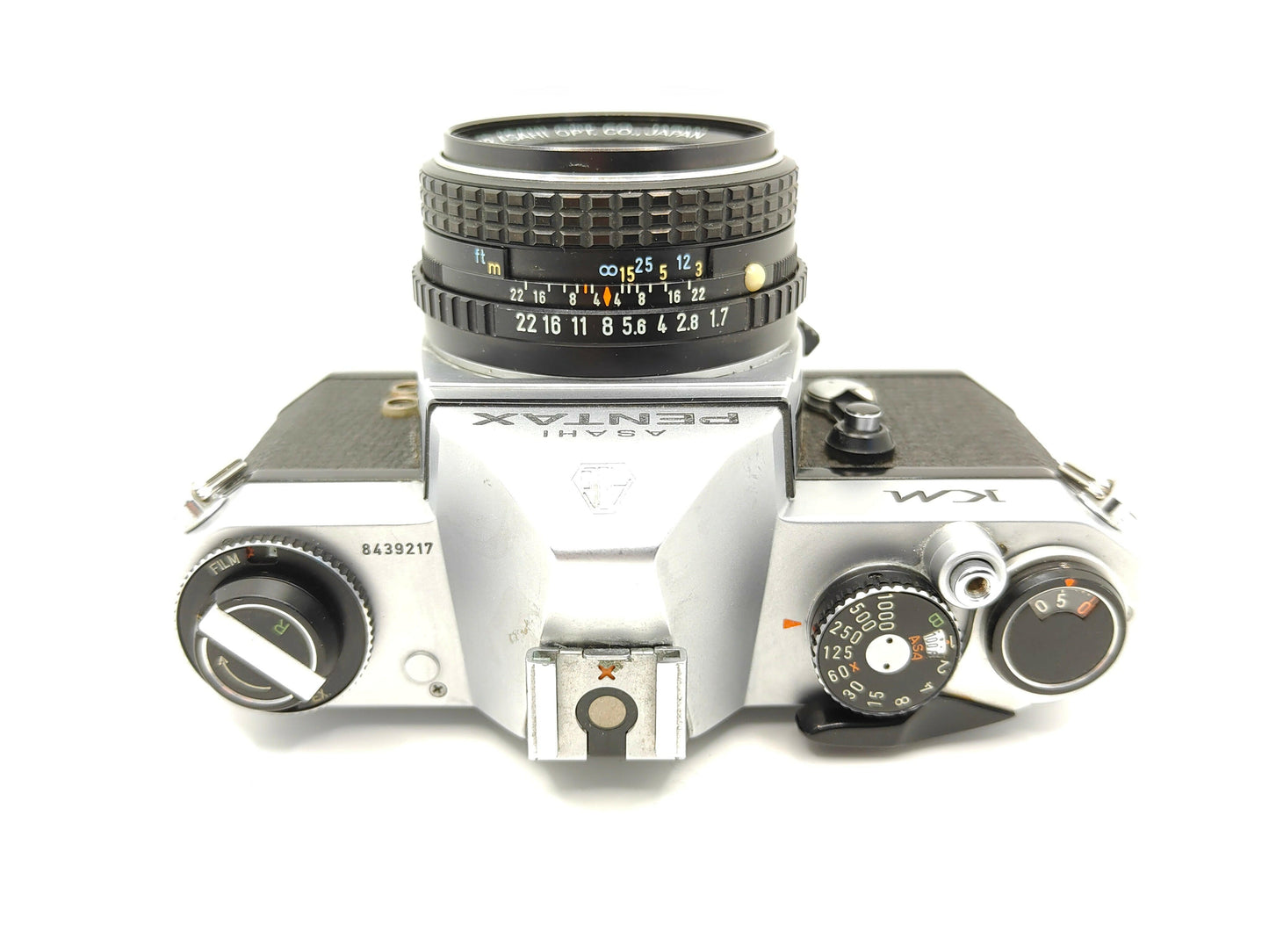 Pentax KM SLR film camera with 55mm f/1.8 lens.