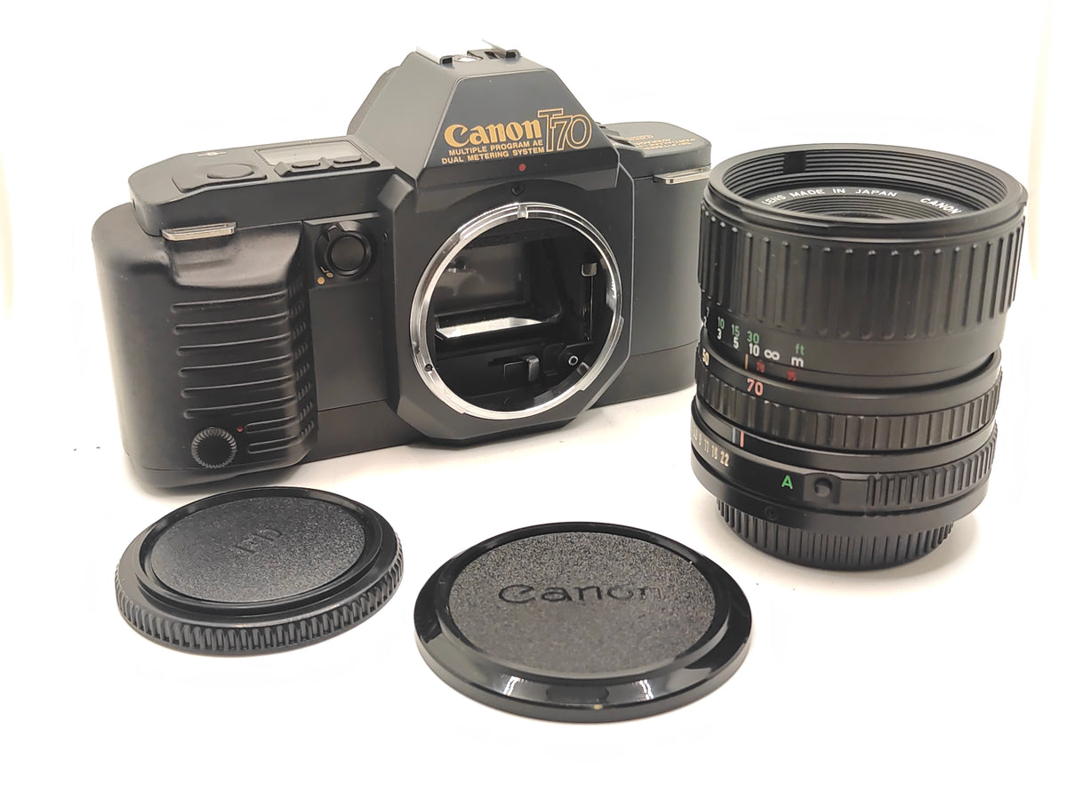 Canon T70 SLR camera + 35-70mm zoom lens in original box.