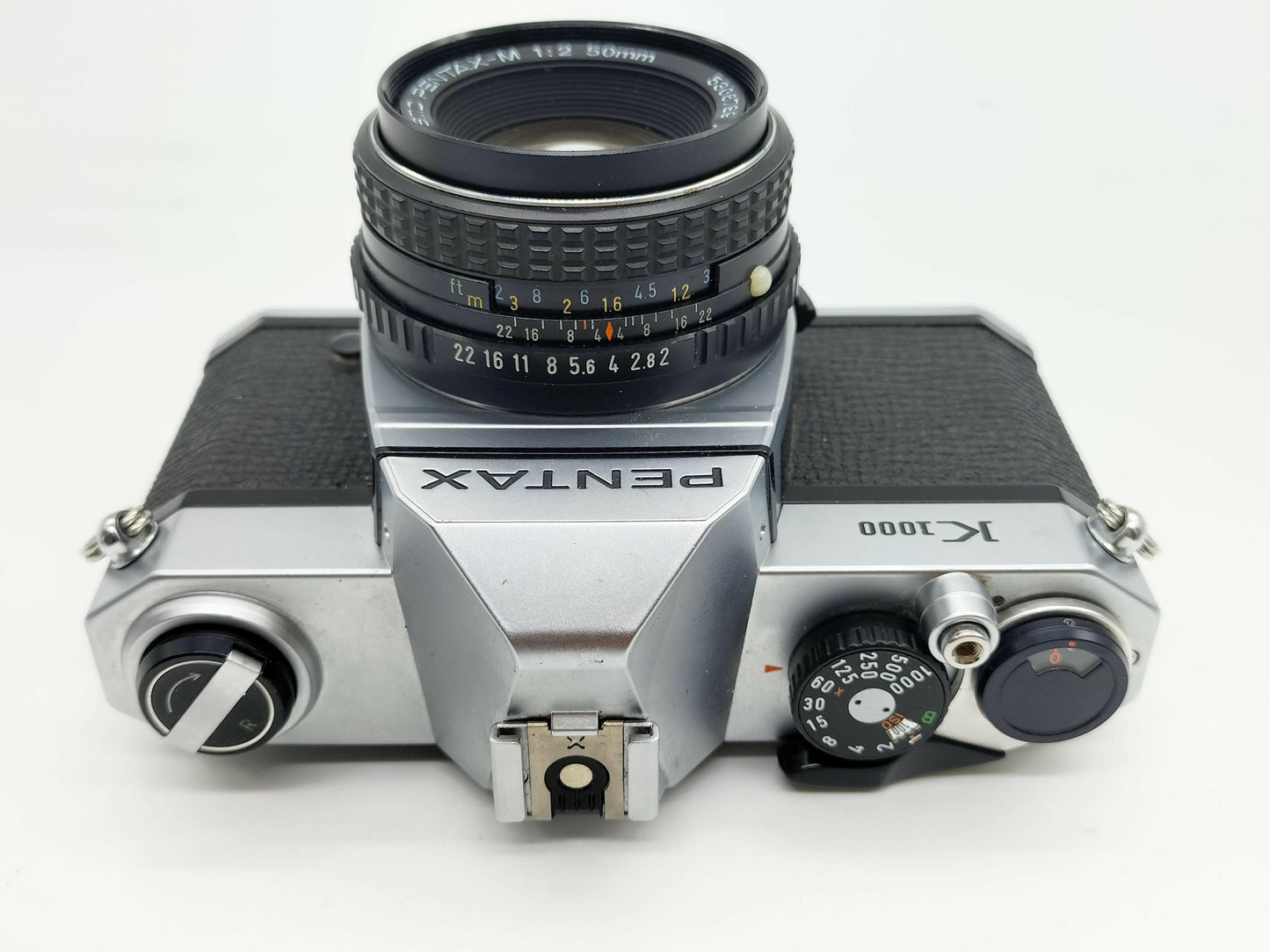 Pentax K1000 SLR film camera with 50mm lens.