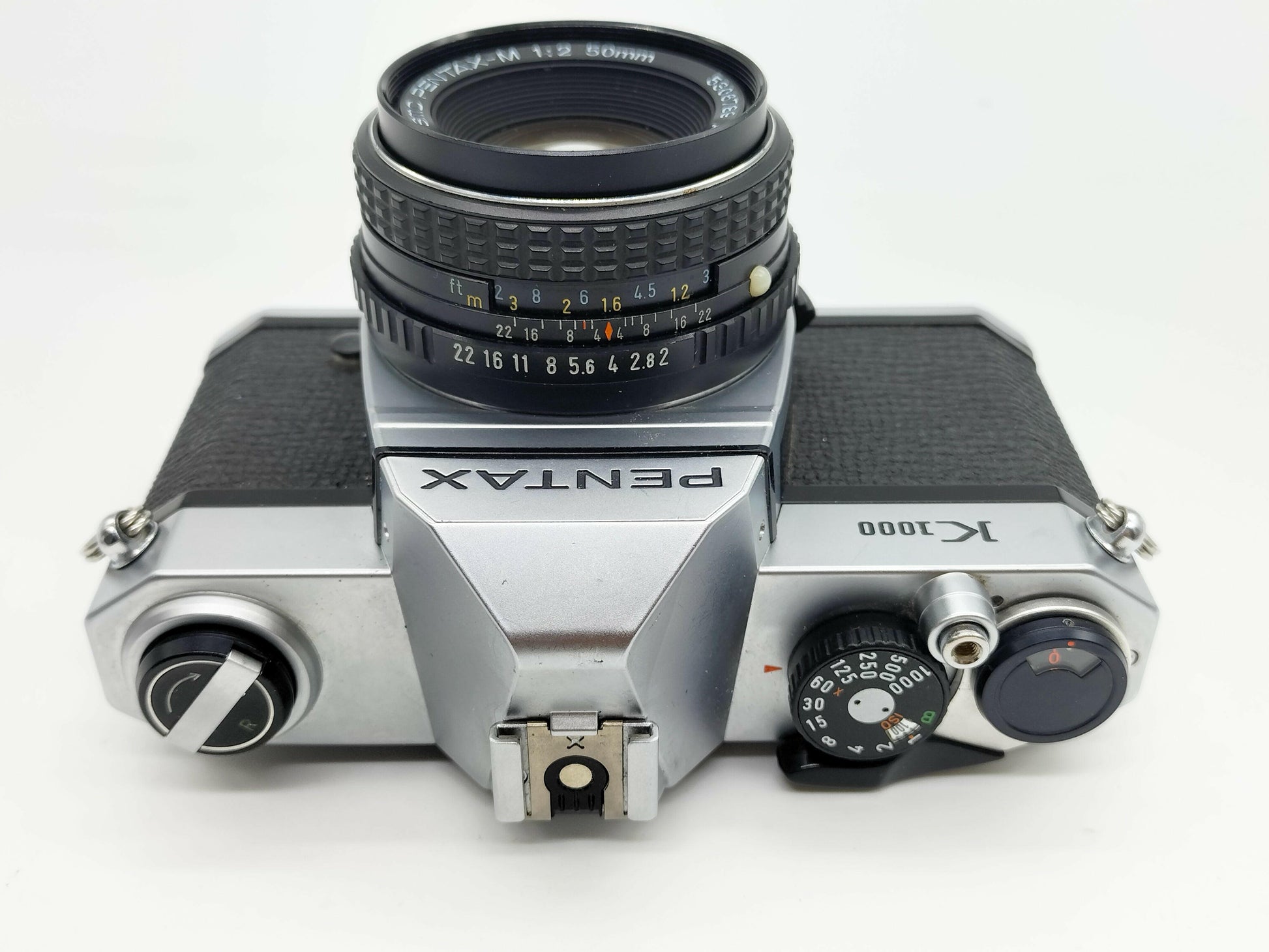 Pentax K1000 SLR film camera with 50mm lens.