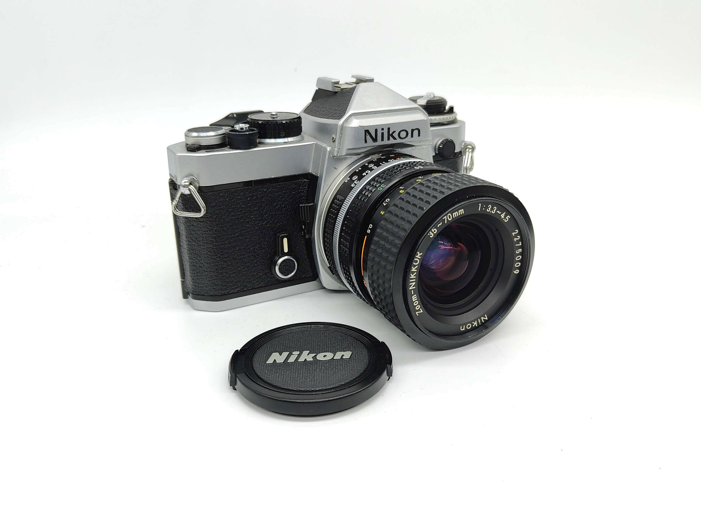 Nikon FE SLR (silver) film camera.