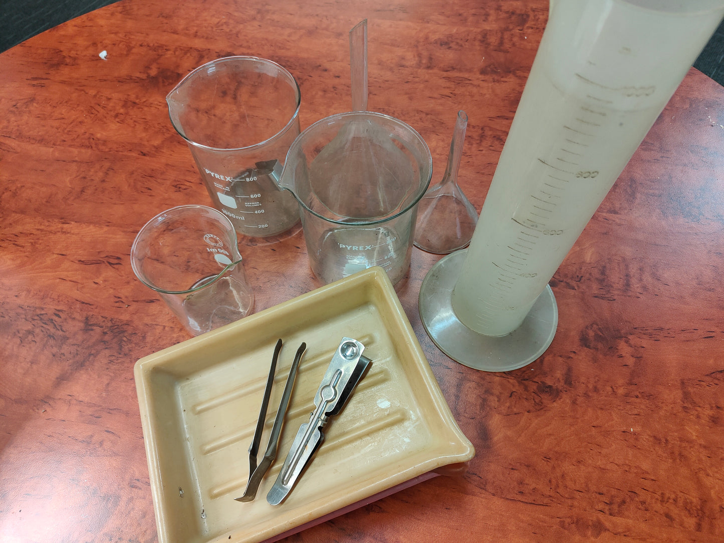 Set of measuring cups, funnels and trays for photo processing