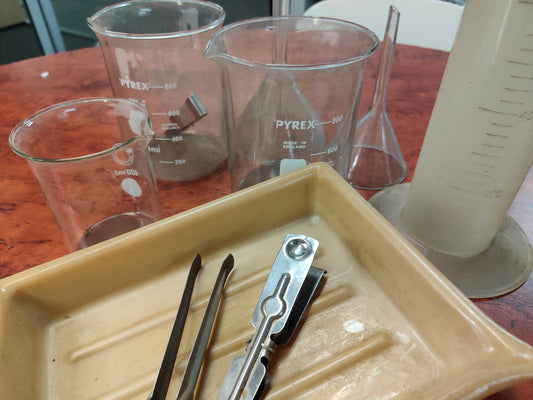 Set of measuring cups, funnels and trays for photo processing