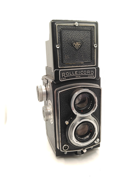 Rolleicord III twin-lens-reflex medium-format camera with leather case.