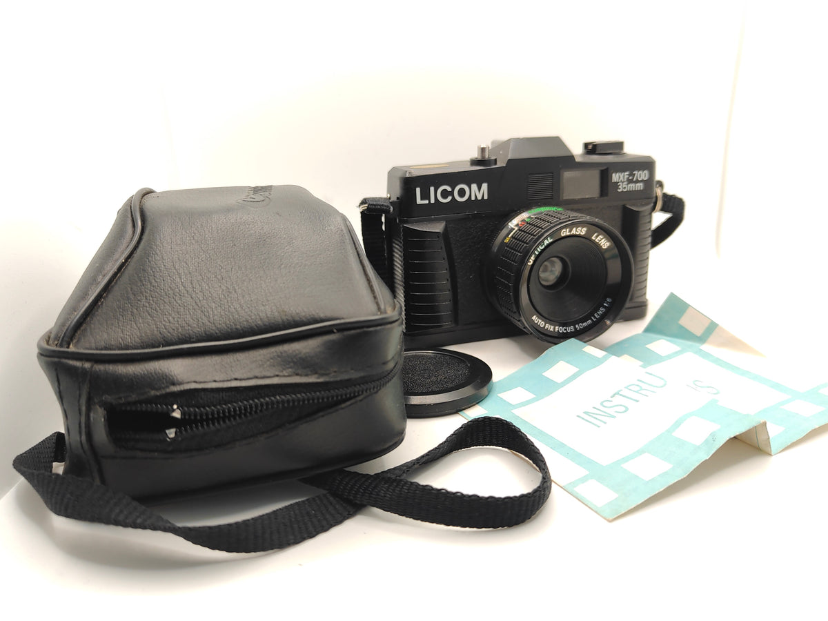 Retro plastic camera with case and manual.